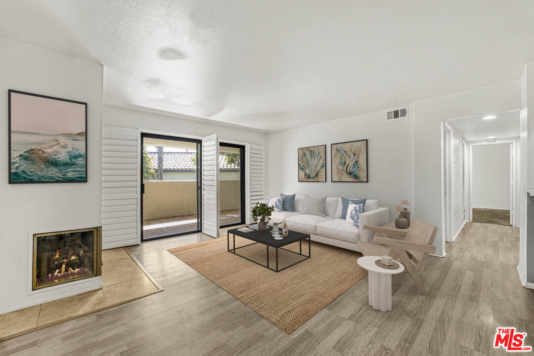 2053 Majorca Drive Oxnard, CA 93035 - Photo 3 of 15 a living room with furniture a wooden floor and a fireplace