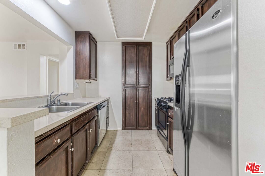 2053 Majorca Drive Oxnard, CA 93035 - Photo 4 of 15 a kitchen with a refrigerator and a sink