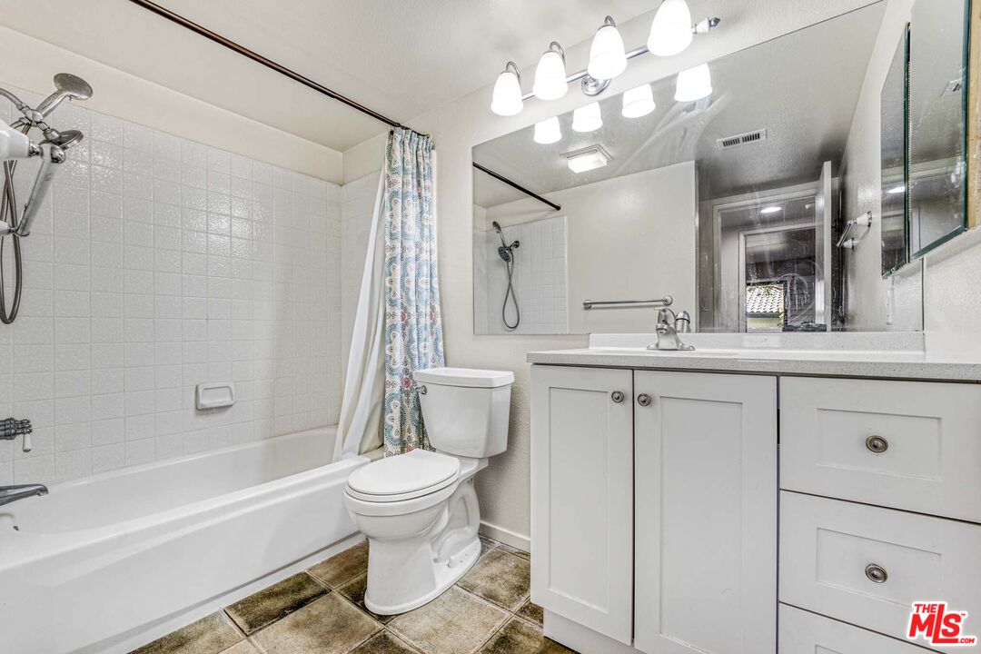 2053 Majorca Drive Oxnard, CA 93035 - Photo 7 of 15 a bathroom with a sink a toilet a mirror a vanity and bathtub