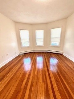 38 Hecla Street, Unit 1 Boston, MA 02122 - Photo 3 of 7 wooden floor in an empty room with a window