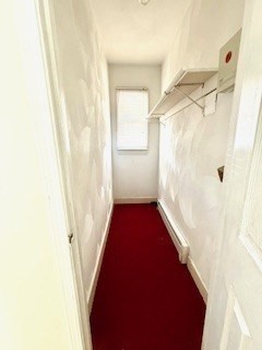 38 Hecla Street, Unit 1 Boston, MA 02122 - Photo 4 of 7 a view of a hallway with wooden floor and a bathroom