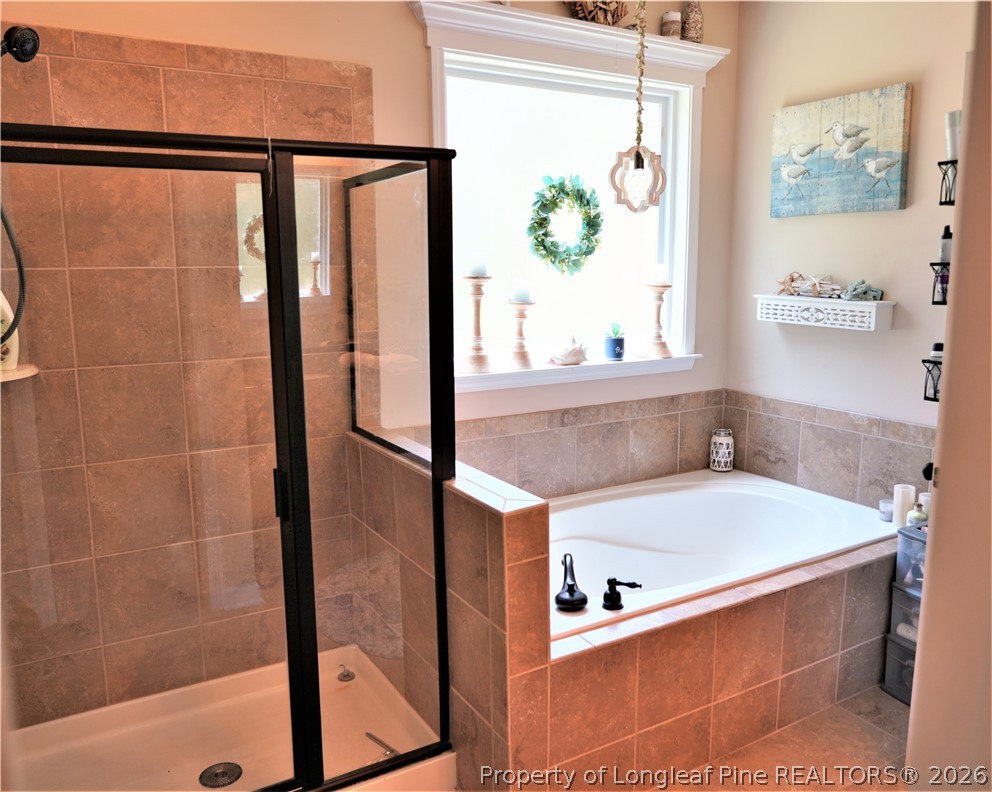 930 Old Vander Road Fayetteville, NC 28312 - Photo 26 of 45 a bathroom with a bathtub and a shower