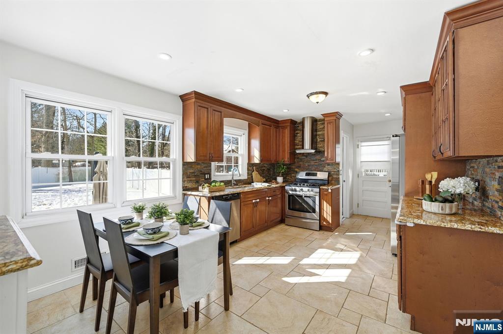 26 East Harrison Place Livingston, NJ 07039 - Photo 15 of 42 a kitchen with a table and chairs in it