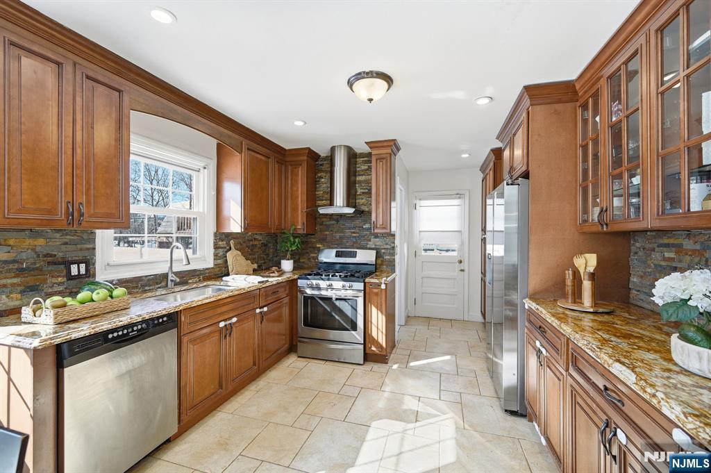 26 East Harrison Place Livingston, NJ 07039 - Photo 17 of 42 a kitchen with stainless steel appliances granite countertop a stove sink and cabinets