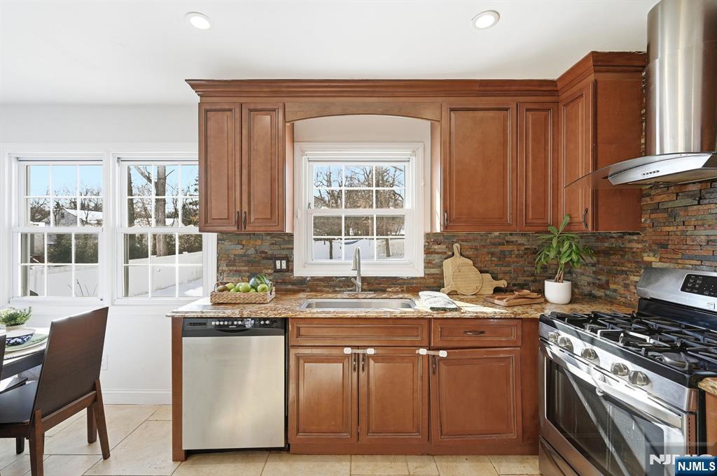 26 East Harrison Place Livingston, NJ 07039 - Photo 20 of 42 a kitchen with stainless steel appliances granite countertop a stove a sink and a microwave
