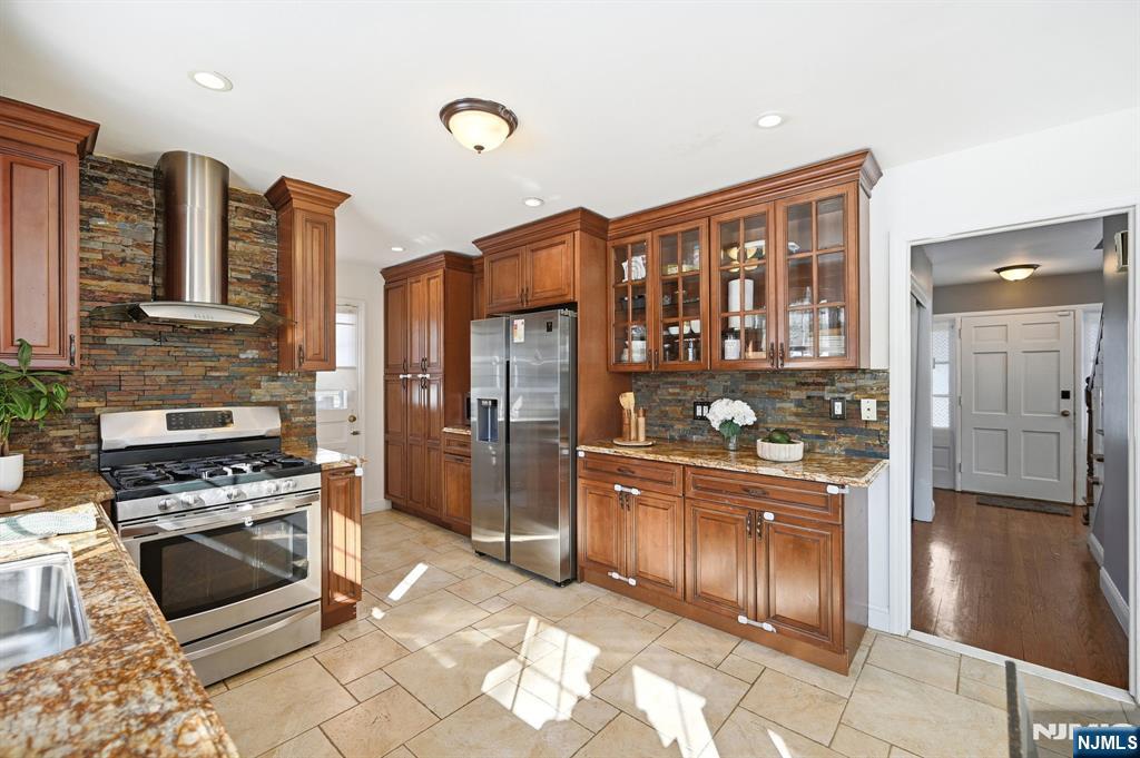 26 East Harrison Place Livingston, NJ 07039 - Photo 22 of 42 a kitchen with stainless steel appliances granite countertop a refrigerator and a stove top oven
