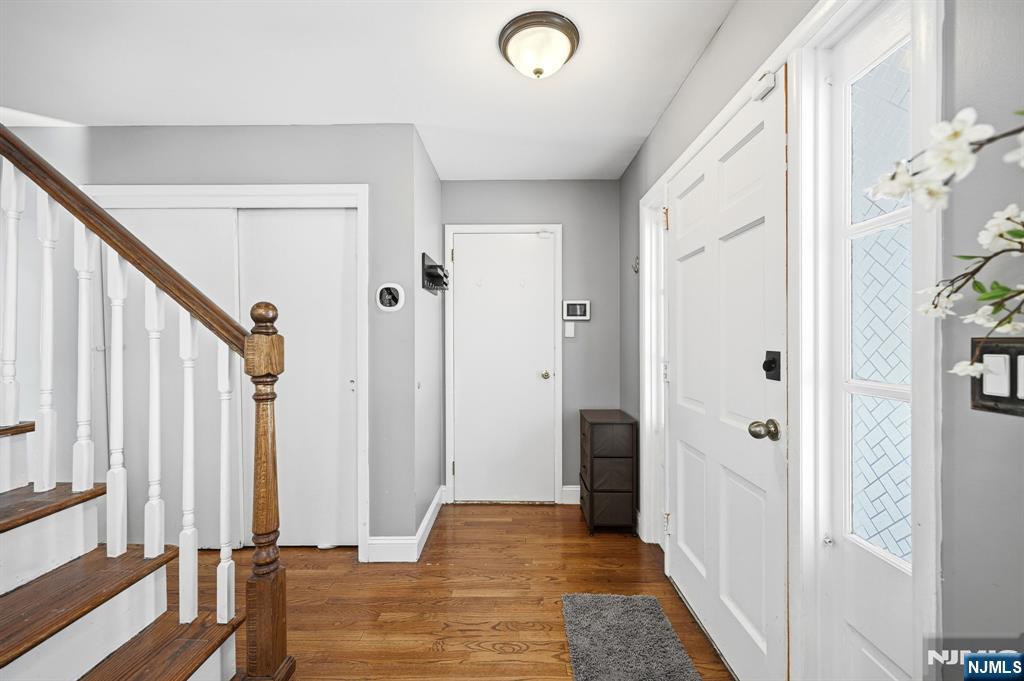 26 East Harrison Place Livingston, NJ 07039 - Photo 4 of 42 a view of a hallway with wooden floor and staircase