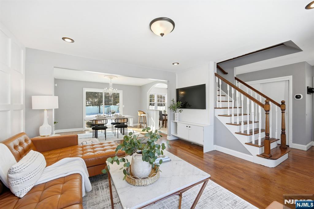 26 East Harrison Place Livingston, NJ 07039 - Photo 8 of 42 a living room with furniture a flat screen tv and a table