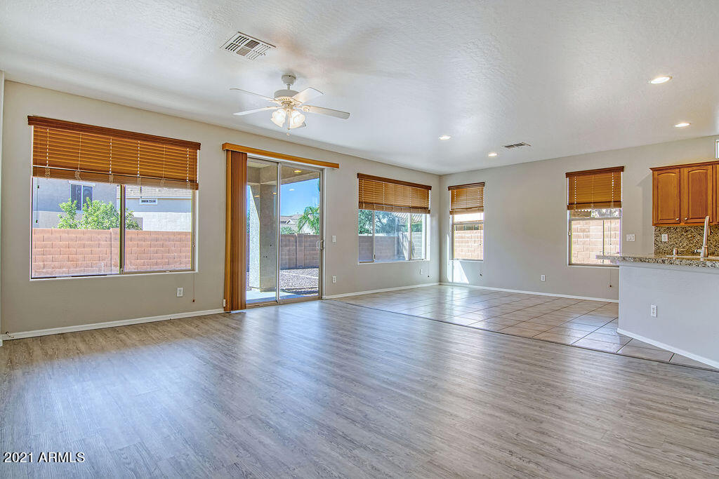 35210 North 30th Drive Phoenix, AZ 85086 - Photo 13 of 37 a view of an empty room with wooden floor and a window