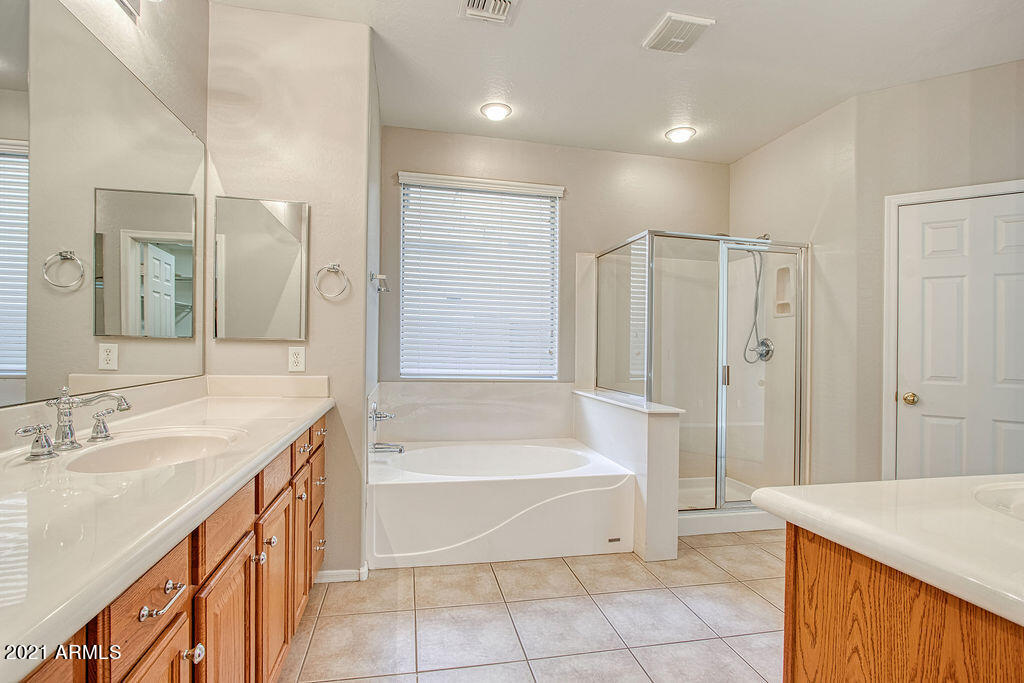 35210 North 30th Drive Phoenix, AZ 85086 - Photo 17 of 37 a spacious bathroom with a tub sink and a mirror