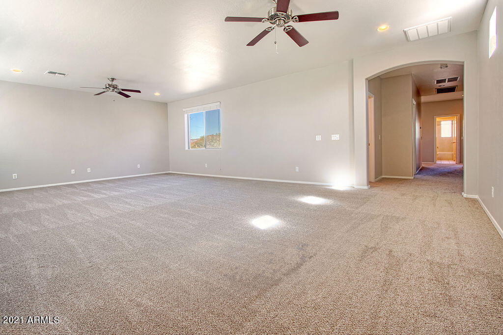 35210 North 30th Drive Phoenix, AZ 85086 - Photo 19 of 37 an empty room with a ceiling fan and a window