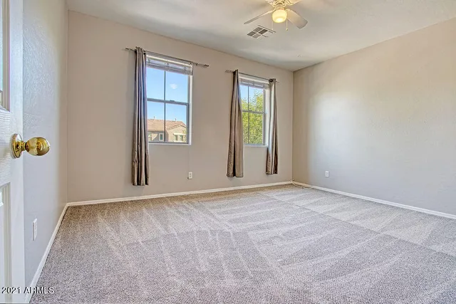 an empty room with windows and closet