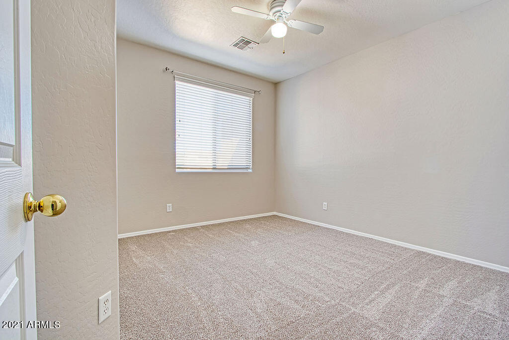 35210 North 30th Drive Phoenix, AZ 85086 - Photo 27 of 37 an empty room with windows and chandelier fan