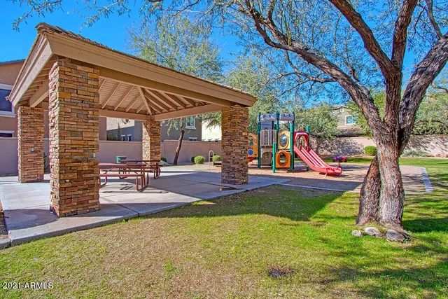 a view of a backyard with swimming pool