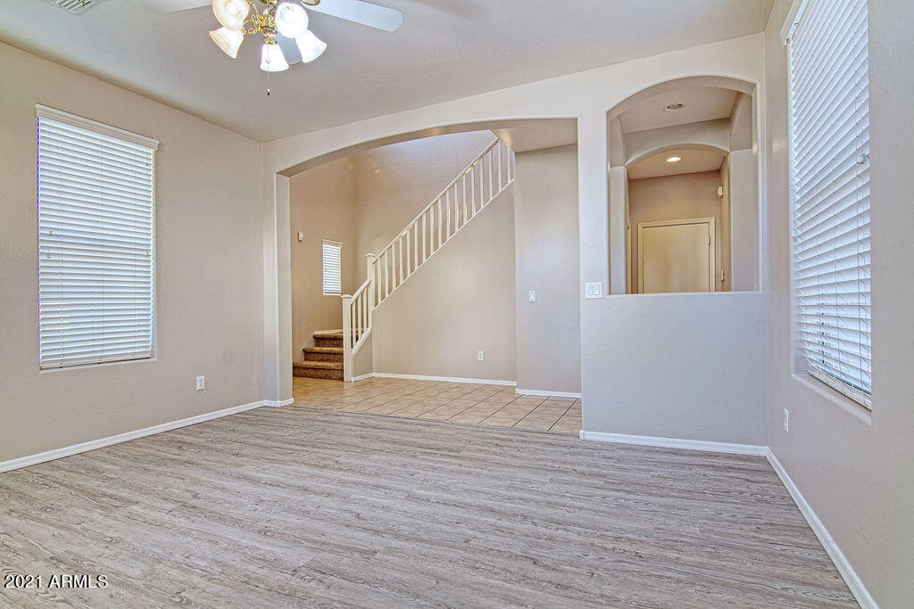 35210 North 30th Drive Phoenix, AZ 85086 - Photo 5 of 37 a view of a livingroom with wooden floor and a ceiling fan