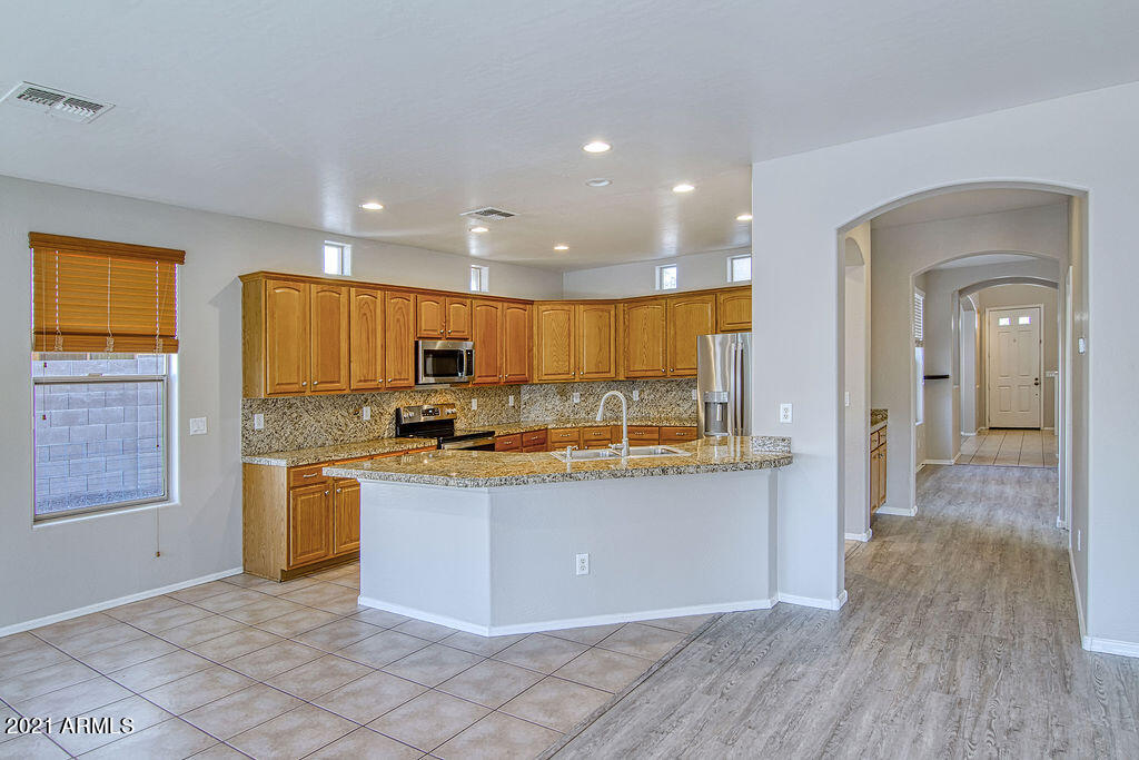 35210 North 30th Drive Phoenix, AZ 85086 - Photo 8 of 37 a kitchen with stainless steel appliances granite countertop a stove a sink and a refrigerator