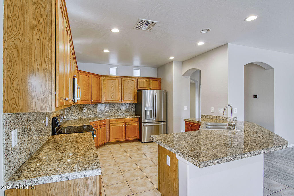 35210 North 30th Drive Phoenix, AZ 85086 - Photo 9 of 37 a kitchen with stainless steel appliances granite countertop a sink and a refrigerator