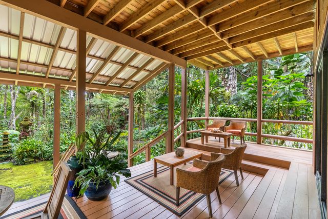 a view of a patio with table and chairs and wooden floor