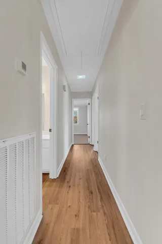 a view of hallway with wooden floor