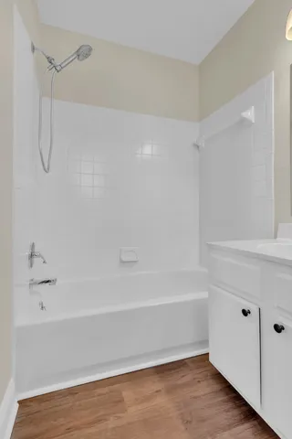 a bathroom with a shower and a bath tub