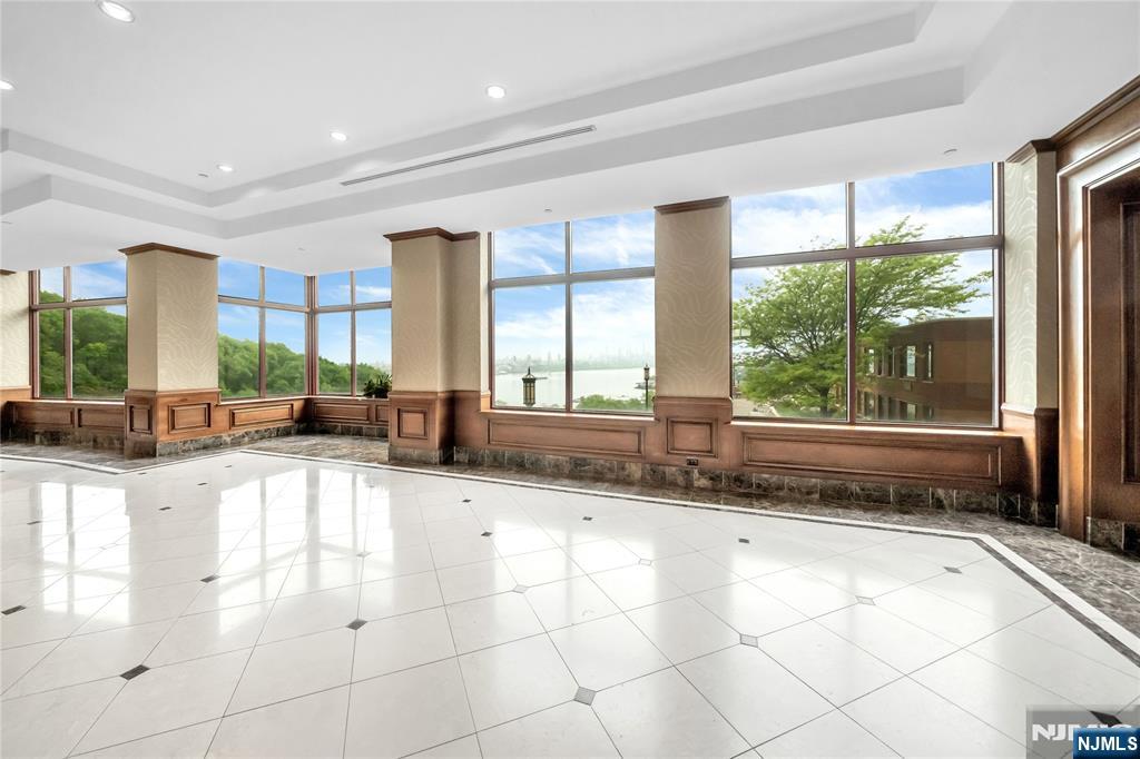 100 Old Palisade Road, Unit 1710 Fort Lee, NJ 07024 - Photo 2 of 8 a large kitchen with kitchen island granite countertop a large window in it