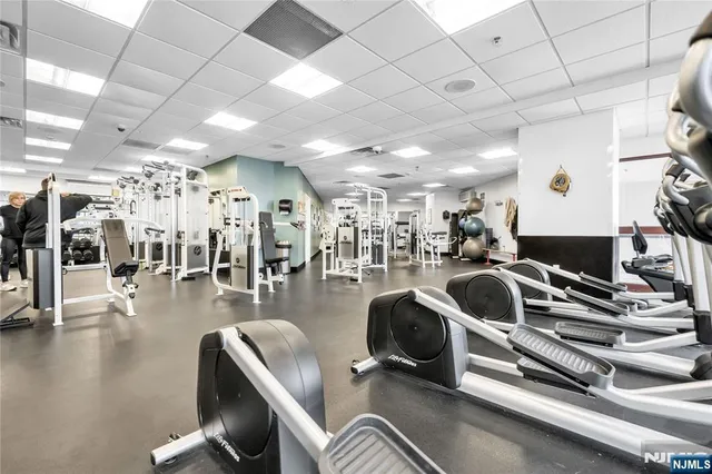 a gym room with lots of gym equipment
