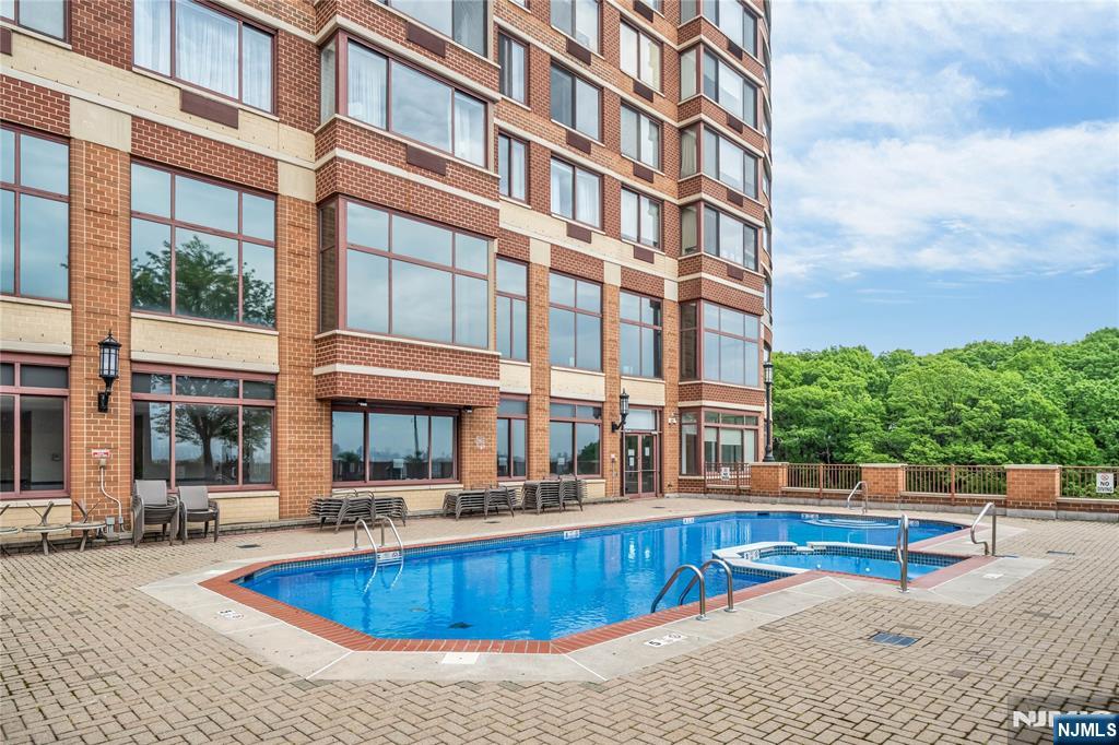 100 Old Palisade Road, Unit 1710 Fort Lee, NJ 07024 - Photo 7 of 8 a view of a building with a swimming pool and sitting area