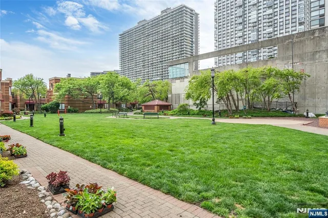 a view of a garden with a building in the background