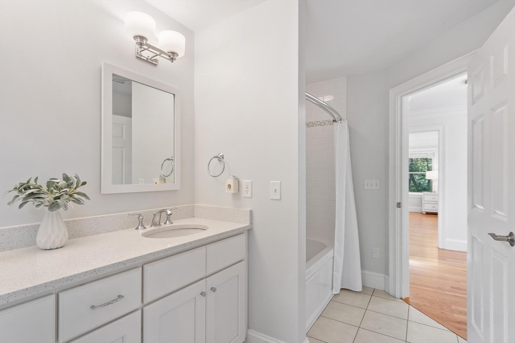 56 Old Marlboro Road Concord, MA 01742 - Photo 17 of 34 a bathroom with a sink a mirror and a shower