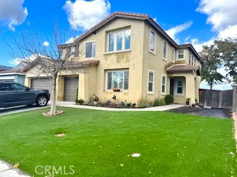 a front view of a house with a garden and yard