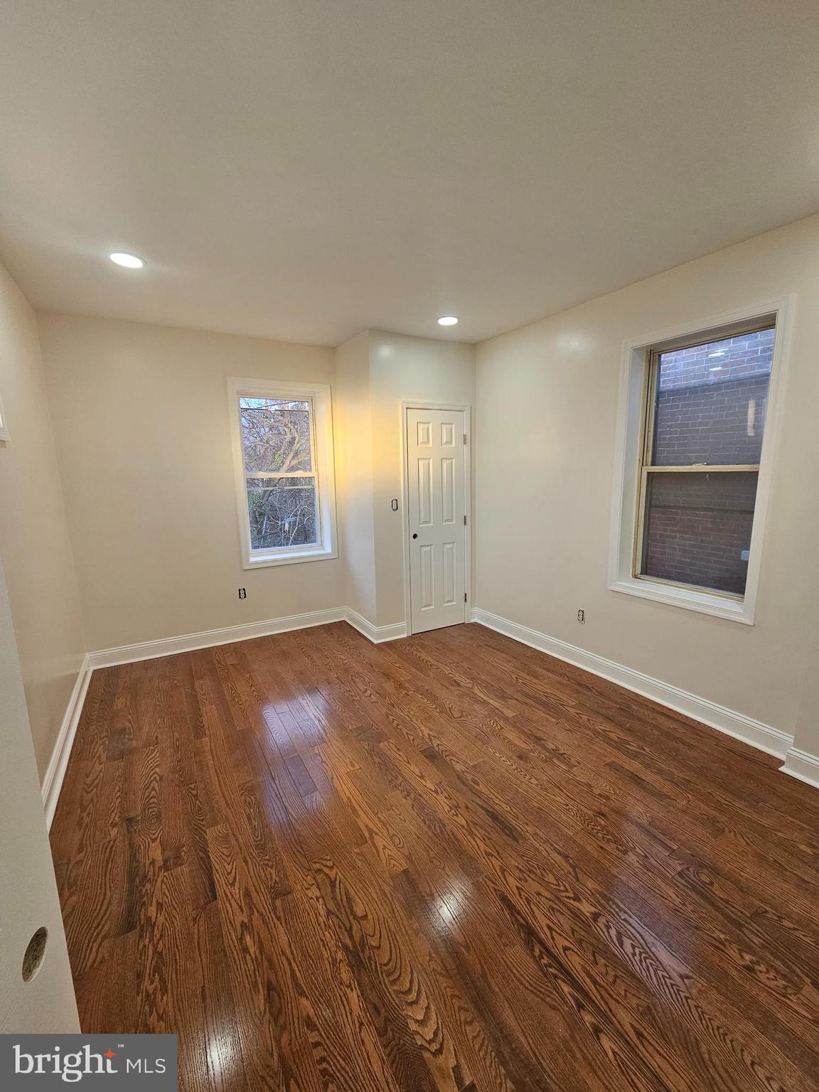6047 Race Street Philadelphia, PA 19139 - Photo 8 of 23 an empty room with wooden floor and windows