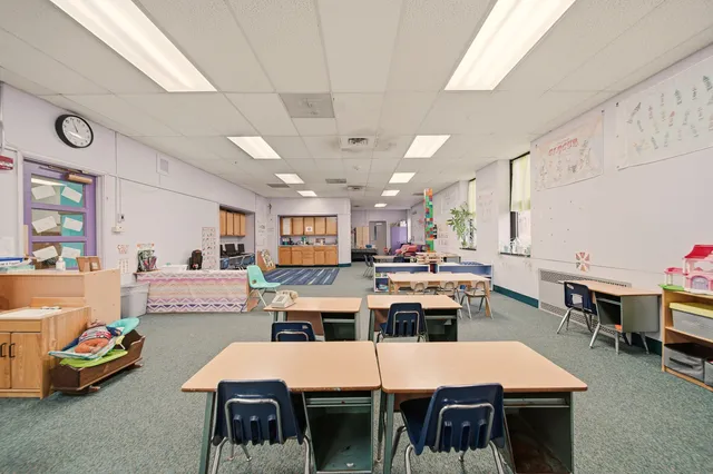 a large kitchen with a table and chairs