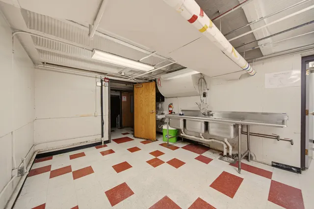 a living room with lots of furniture and a view of kitchen