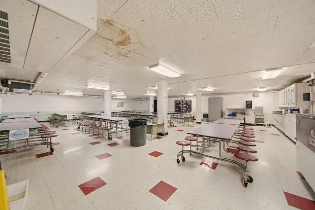 a kitchen with a sink a stove and chairs