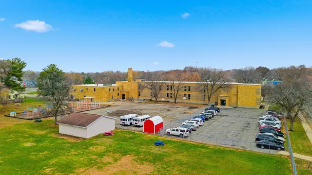 a view of a house with pool and a yard