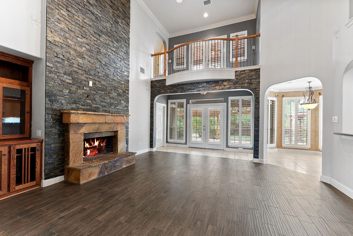 7938 Wooded Way Drive Spring, TX 77389 - Photo 13 of 47 The living room boasts soaring two-story ceilings and an abundance of windows that frame stunning views of the backyard and surrounding nature