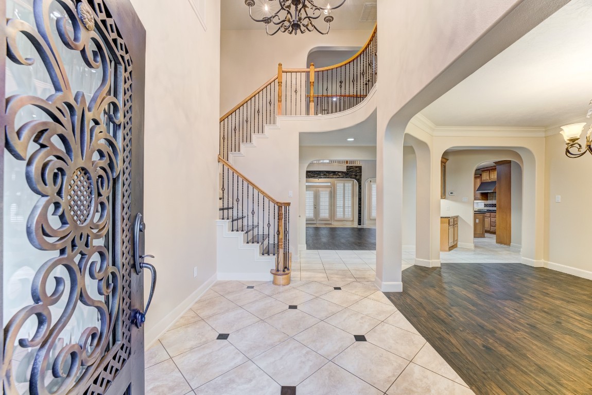 7938 Wooded Way Drive Spring, TX 77389 - Photo 3 of 47 An impressive sweeping curved staircase with wrought iron spindles makes a statement in this two-story grand foyer.