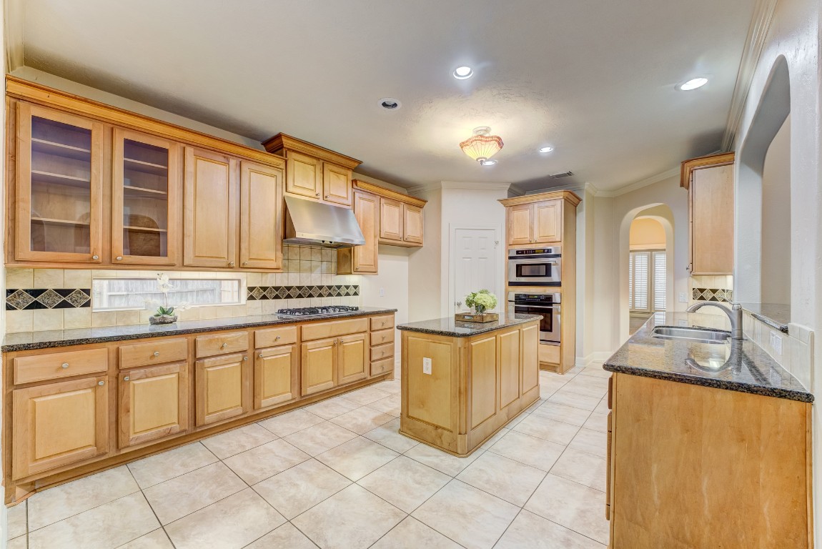 7938 Wooded Way Drive Spring, TX 77389 - Photo 8 of 47 The Open Island adds an extended work space and entertaining area; Under cabinet recessed lighting keeps the kitchen light and bright!