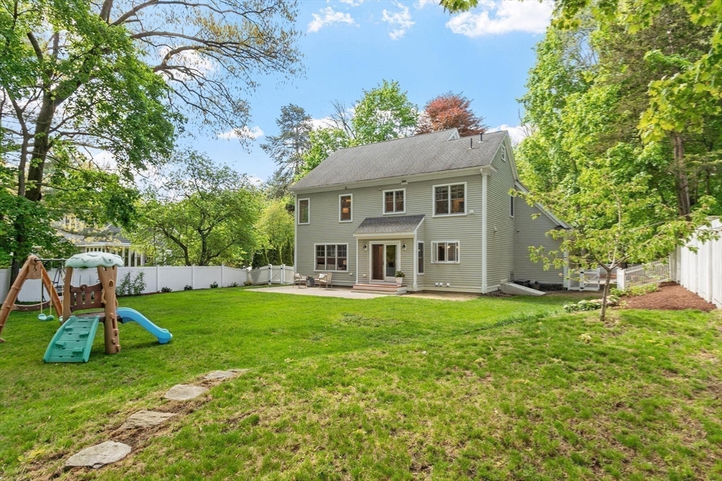 56 Old Marlboro Road Concord, MA 01742 - Photo 24 of 34 a view of a house with a big yard potted plants and a large tree