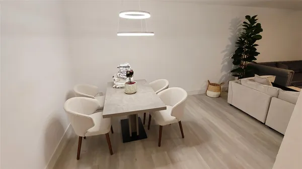 a view of a dining room with furniture and wooden floor