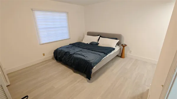 a bedroom with a bed and window