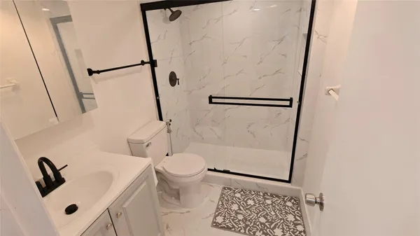 a bathroom with a toilet and a shower