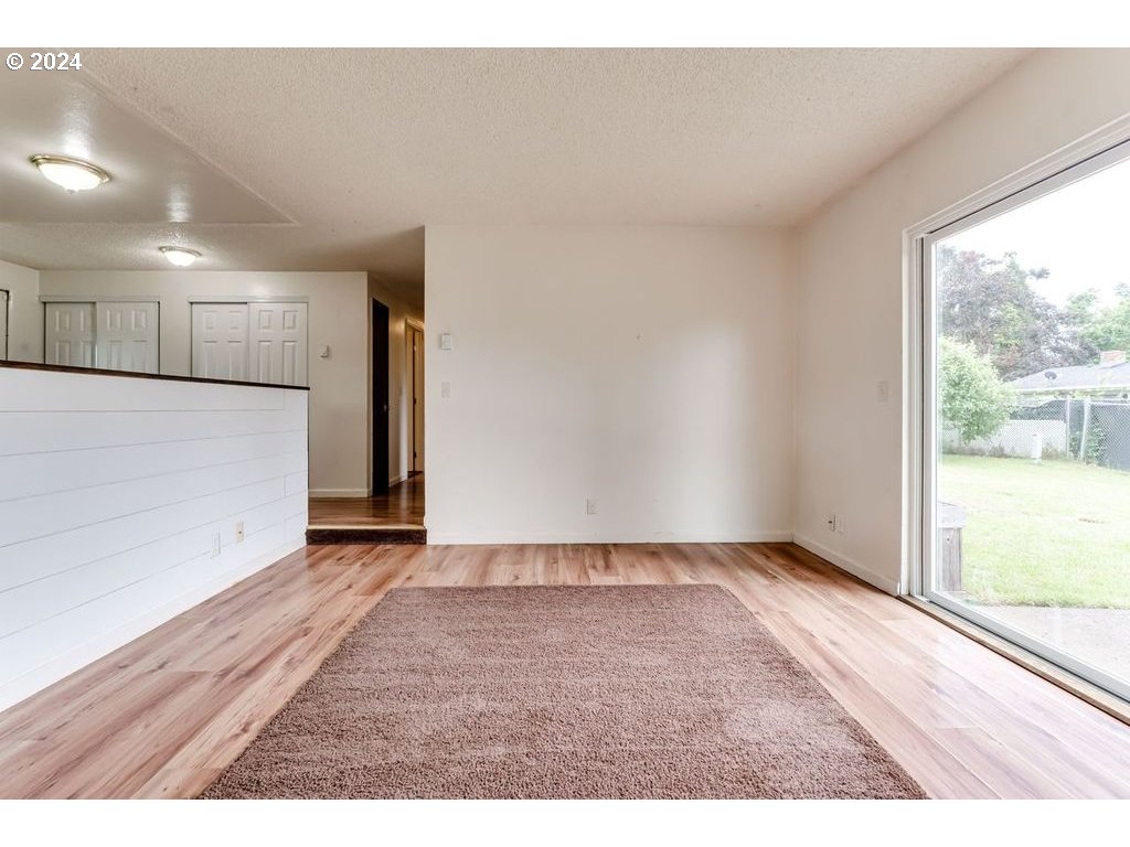 5265 F Street Springfield, OR 97478 - Photo 8 of 17 a view of an empty room with wooden floor and a window