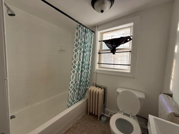 a bathroom with a sink a toilet and bathtub