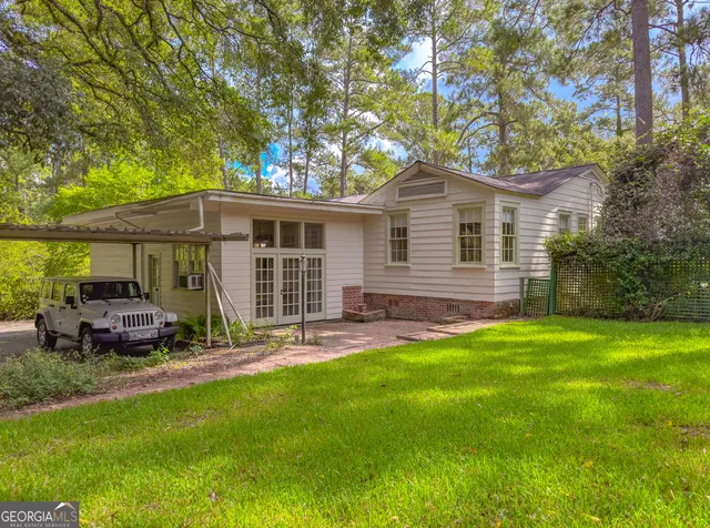 a view of an entryway with wooden floor and a front door