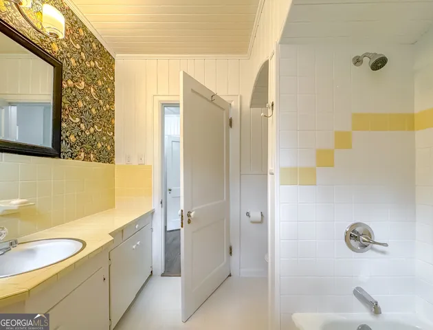 a view of a kitchen with stainless steel appliances granite countertop a sink and a refrigerator