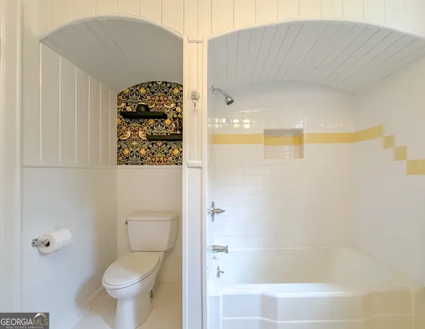 a kitchen with white cabinets and white stainless steel appliances
