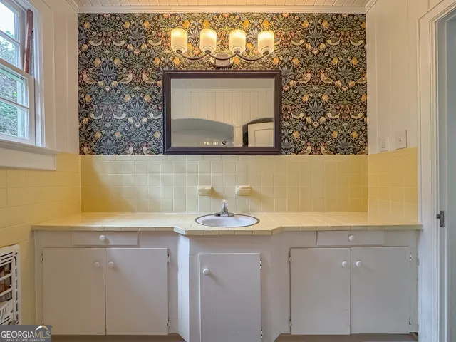 a view of a room with furniture and a window