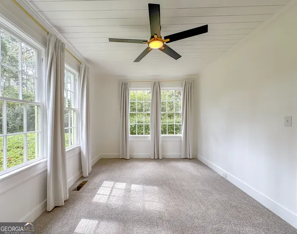 a view of a livingroom with a fireplace a chandelier and wooden floor