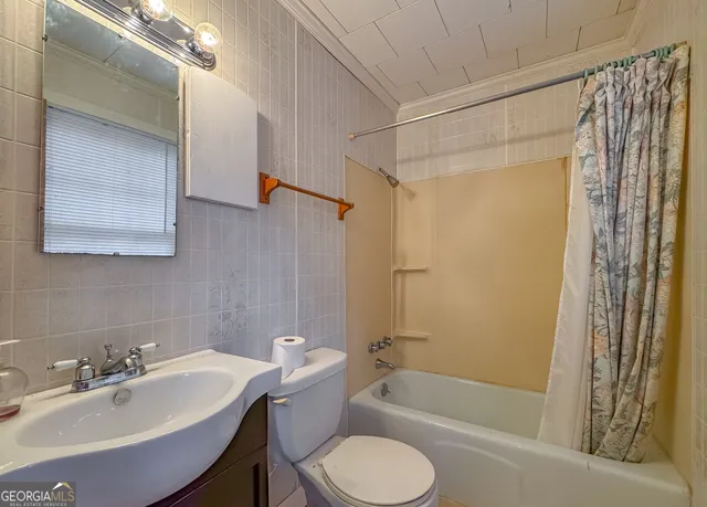 an empty room with windows and cabinet